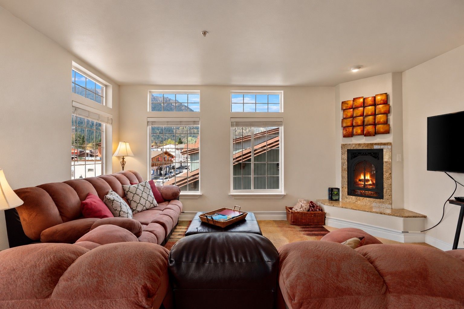 A living room with a fireplace, a sofa set, and a television.