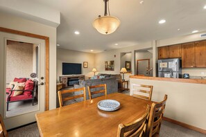 A modern kitchen with wooden cabinets, a built-in oven, and a refrigerator. - Pet-friendly, Two-Level Condo Downtown (Leavenworth)
