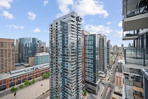A high-rise building with a modern glass facade, surrounded by other tall buildings in an urban setting.
