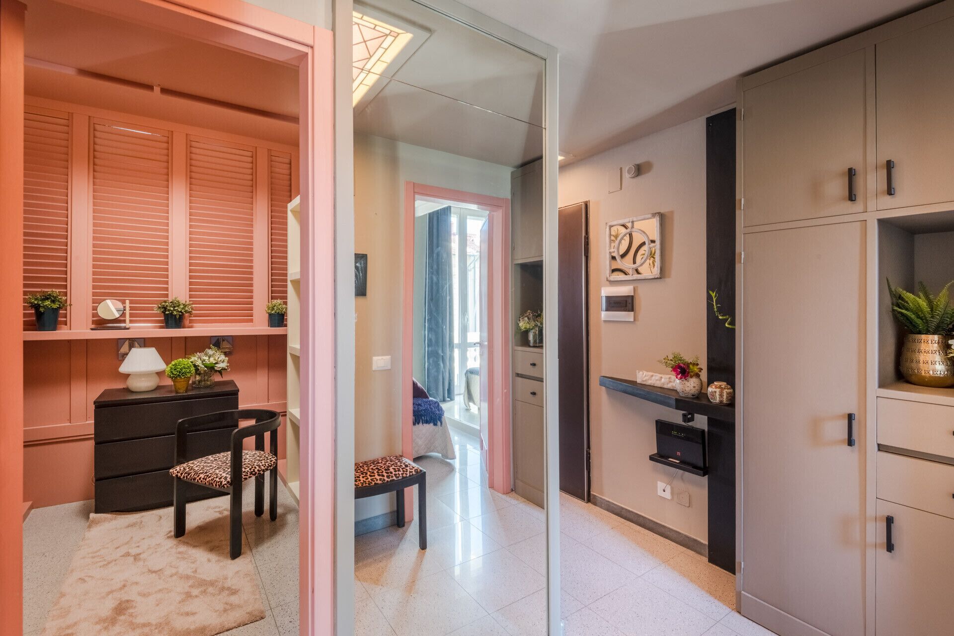A modern interior with a desk, chairs, and a wardrobe.