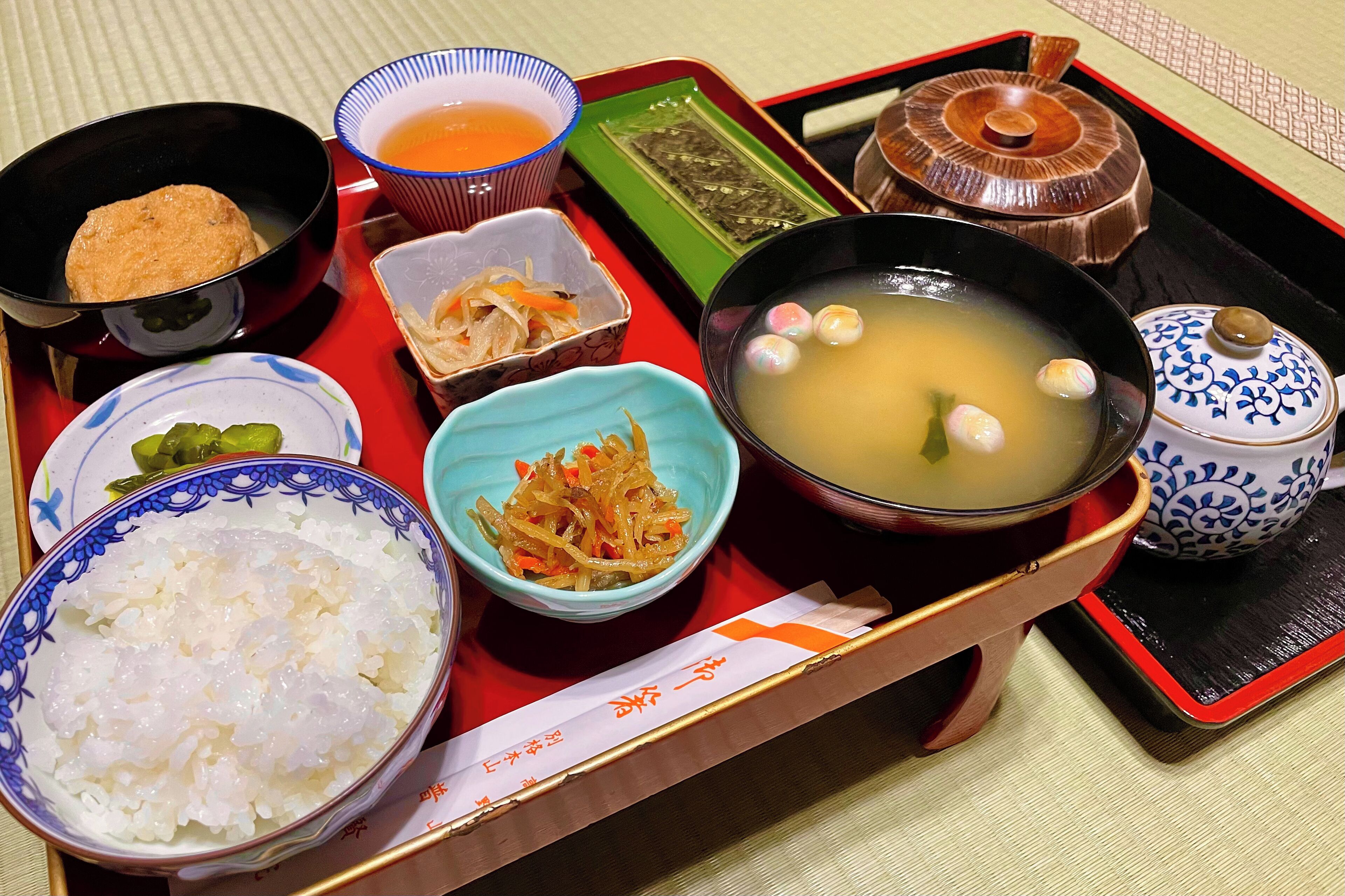 A traditional Japanese meal with various dishes on a tray.