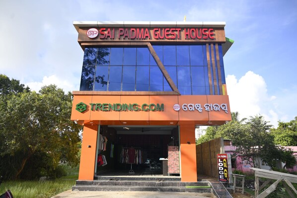A building with a sign reading "Sai Padma Guest House" and a website address "trending.com". - Sai Padma Guest House (Gop)