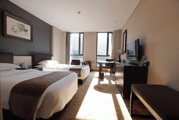 A hotel room with two beds, a desk, a TV, and large windows. - Weichang Qianyue Holiday Hotel (Government Branch) (Weichang)