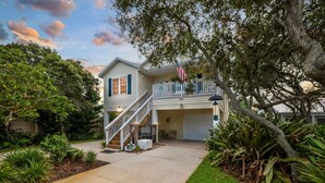 A two-story house with a front porch, a staircase, and a garage. - Heated Pool, Spa & Tiki Bar! Full Garage Game Room and Steps Away From The Beach (St. Augustine)