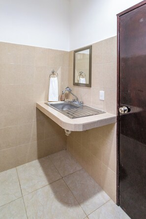 A bathroom with a sink, mirror, and towel rack. - Villa Bugambilias Near Bacalar Lagoon (Bacalar)