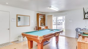 A pool table in a room with a door, a mirror, and a window. - Sunny Hilo Home w/ Game Room: Walk to Golf Course! (Hilo)