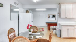 A compact living space with a dining area, kitchenette, and a pool table. - Sunny Hilo Home w/ Game Room: Walk to Golf Course! (Hilo)