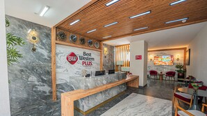 A reception area with a marble reception desk, wooden panel ceiling, and a sign reading "Best Western PLUS." - Best Western Plus Hotel & Residences Istanbul (Istanbul)