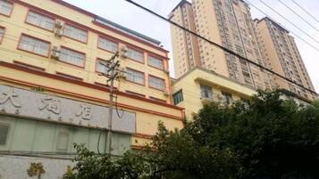 A multi-story building with a sign indicating a hotel.
