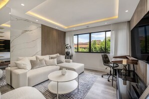 A modern living room with a sectional sofa, a round coffee table, and a TV stand. - delite* Elite Heaven:Luxurious1Bed+1bath (Medellín)