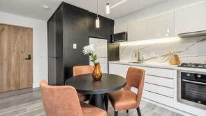 A modern kitchen with white cabinets, a black countertop, and stainless steel appliances. - delite* Elite Heaven:Luxurious1Bed+1bath (Medellín)