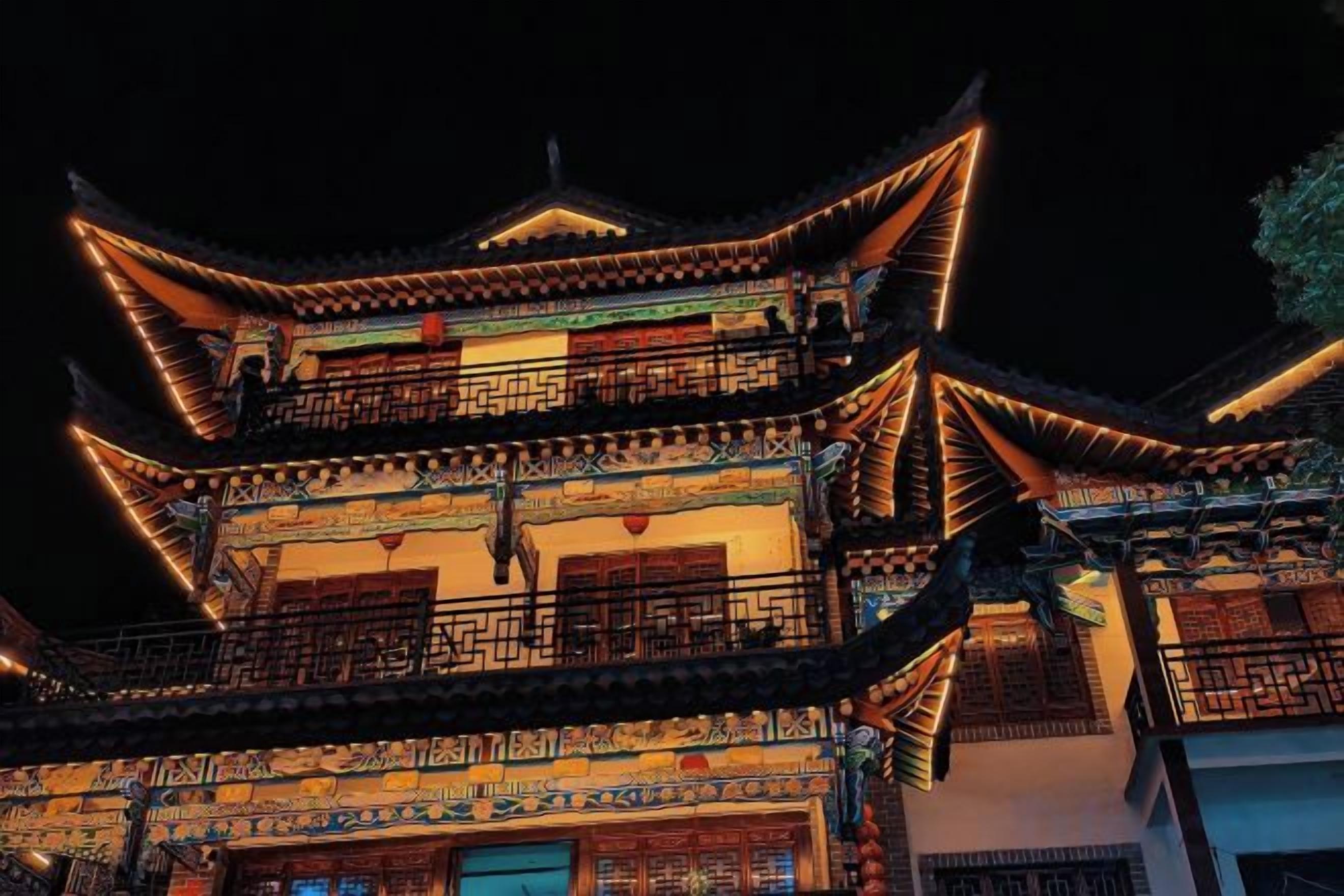 A multi-story building with traditional architecture, featuring ornate balconies and detailed wall decorations.