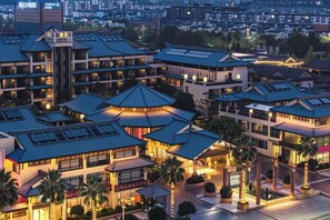 A hotel complex with multiple buildings, some with flat roofs and others with peaked roofs, arranged in a clustered layout. - JP Hyllis Hotel (Chuxiong City)