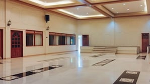 A spacious hotel lobby with a polished floor, a staircase, and traditional decor. - Casa Nena Hotel and Resort Iloilo (Miagao)