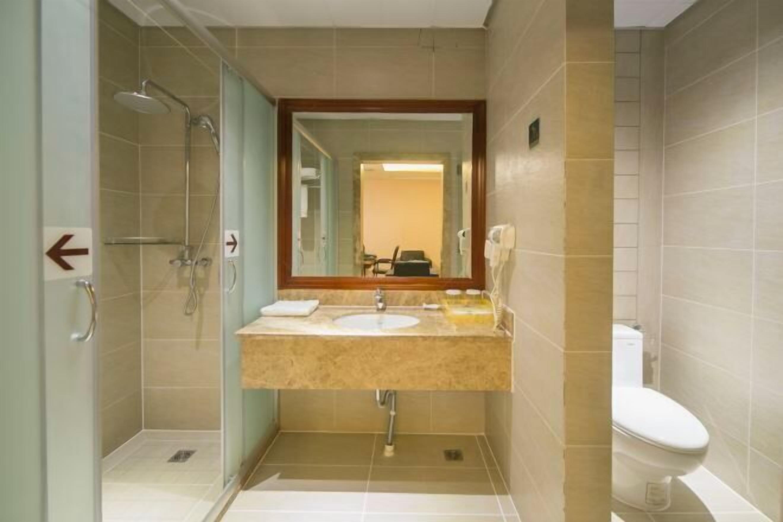 A bathroom with a shower, sink, and toilet.