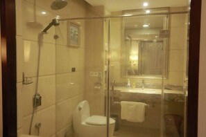 A modern bathroom with a glass-enclosed shower, a toilet, and a sink with a mirror above it. - Ruijin Hotel (Dabu)