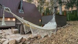A hammock in a backyard with a stone pathway, a wooden deck, and a metal building. - Sunflower Lodge Near Park City (Silver Summit)