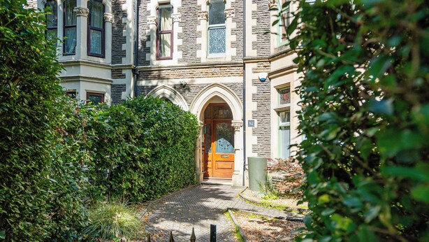 A historic building with a prominent entrance, a stone facade, and a traditional arched doorway. - The Regency Studio (Cardiff)