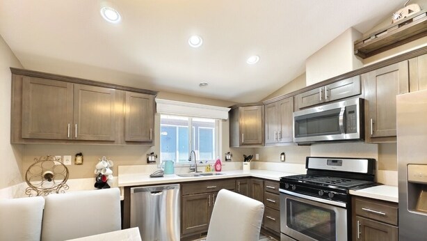 A modern kitchen with stainless steel appliances, wooden cabinets, and a dining area with a white table and chairs. - #4-cnvnt 4B3B fits 8PPL, 15 mins walk to heavenly (South Lake Tahoe)