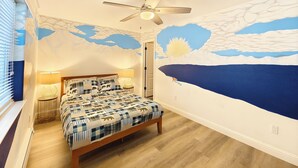A bedroom with a bed, a ceiling fan, a wall mural, and a window with blinds. - #4-cnvnt 4B3B fits 8PPL, 15 mins walk to heavenly (South Lake Tahoe)