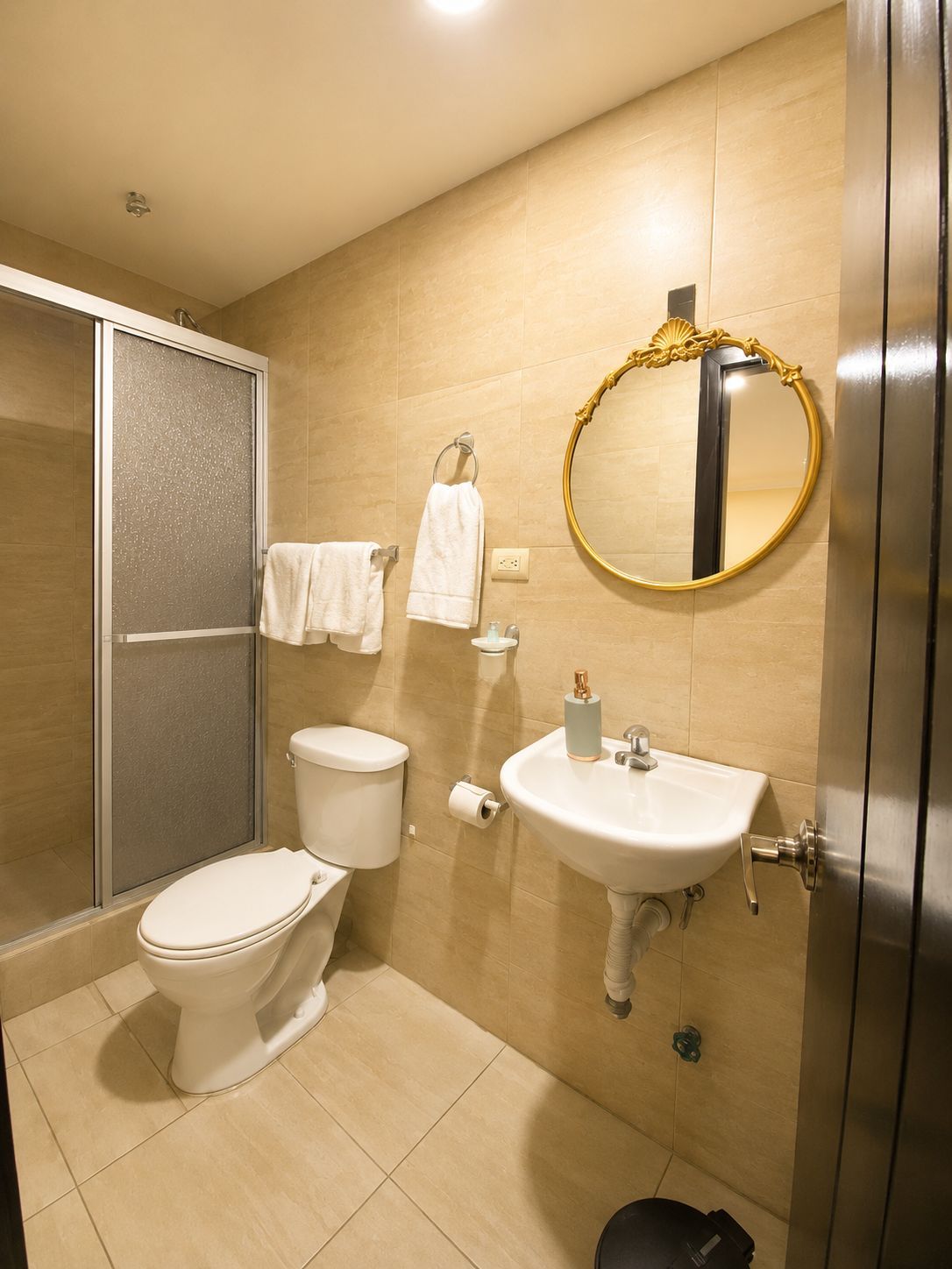 A modern bathroom with a toilet, sink, and shower.