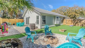 A house with a white exterior, a fenced backyard, and a fire pit. - Beach Retreat with Backyard Flair! w/Yard Games (Atlantic Beach)