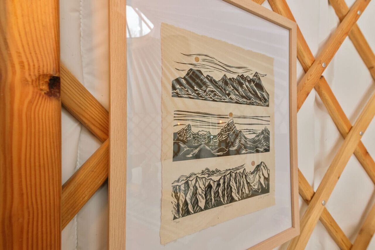 Una obra de arte enmarcada con paisajes de montaña.