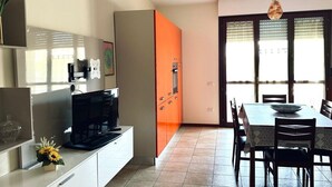 A modern kitchen with a dining area, a built-in oven, and a water dispenser. - SE123 - Marzocca, three-room apartment 300 meters from the sea (Marzocca)