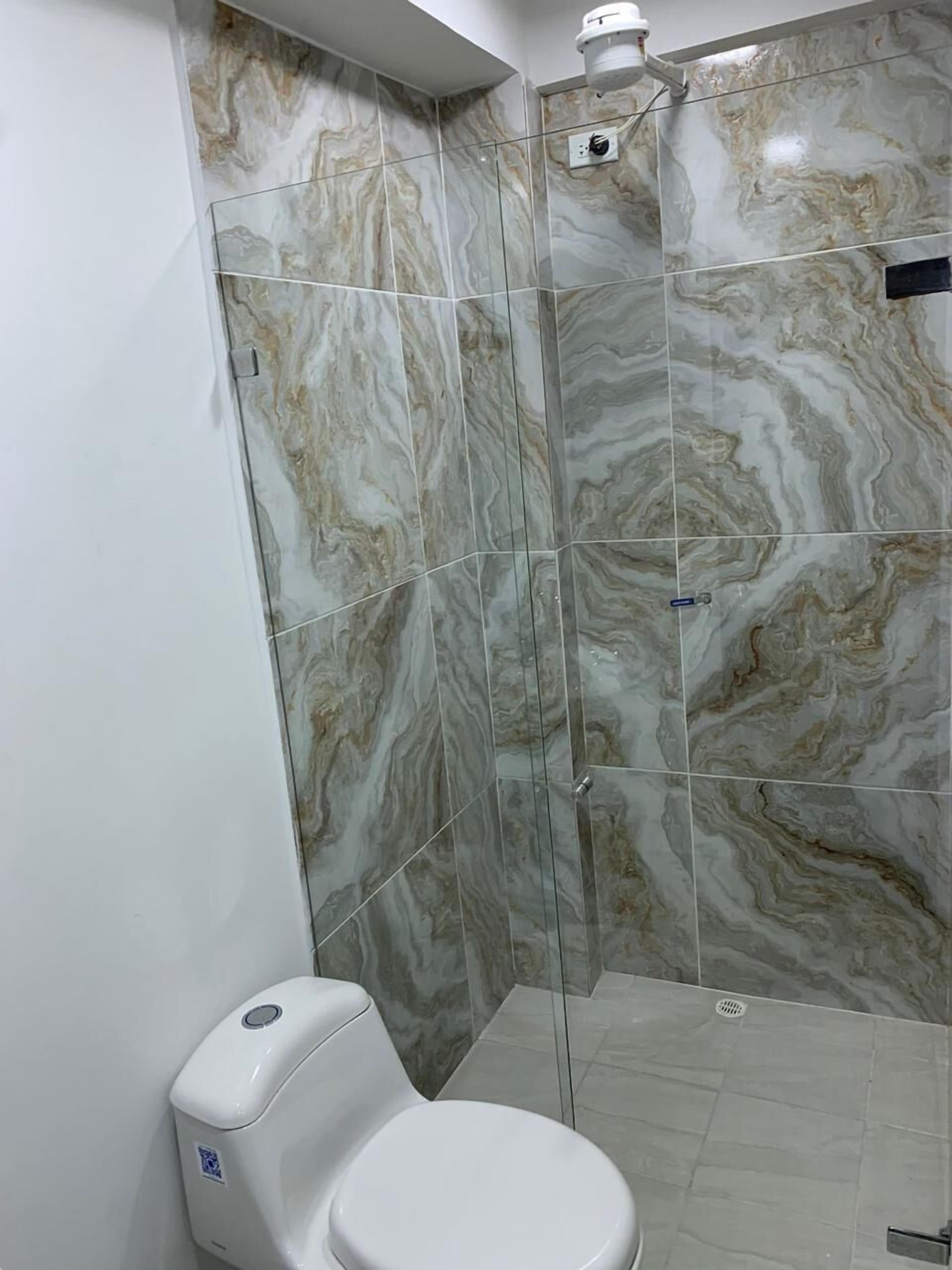 Deluxe Room | Bathroom | Shower, towels, soap, toilet paper