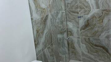 Deluxe Room | Bathroom | Shower, towels, soap, toilet paper