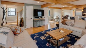 A spacious living room with a large sofa, a coffee table, and a TV mounted on the wall. - Luxury House in Lincoln (Lincoln)