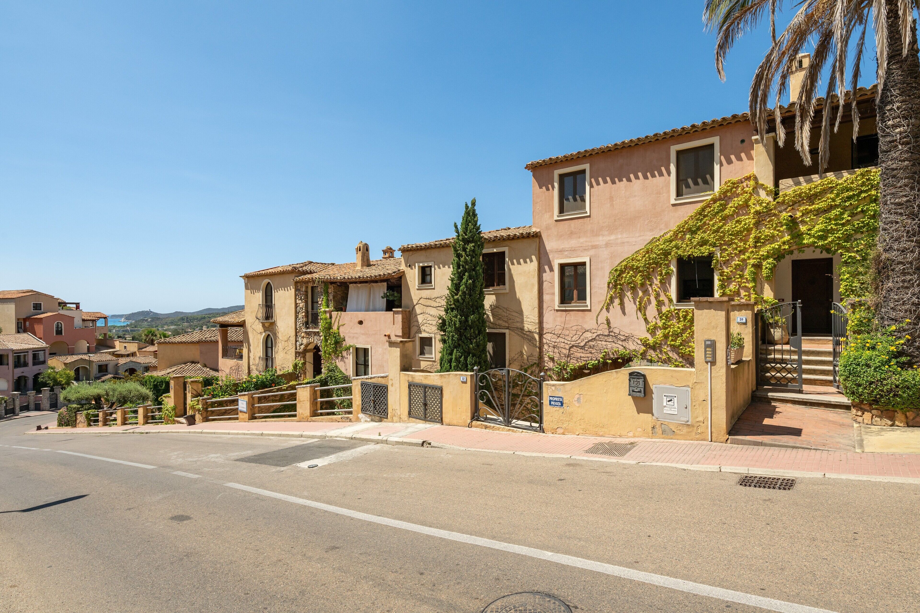A street view with buildings, a clear sky, and a road.