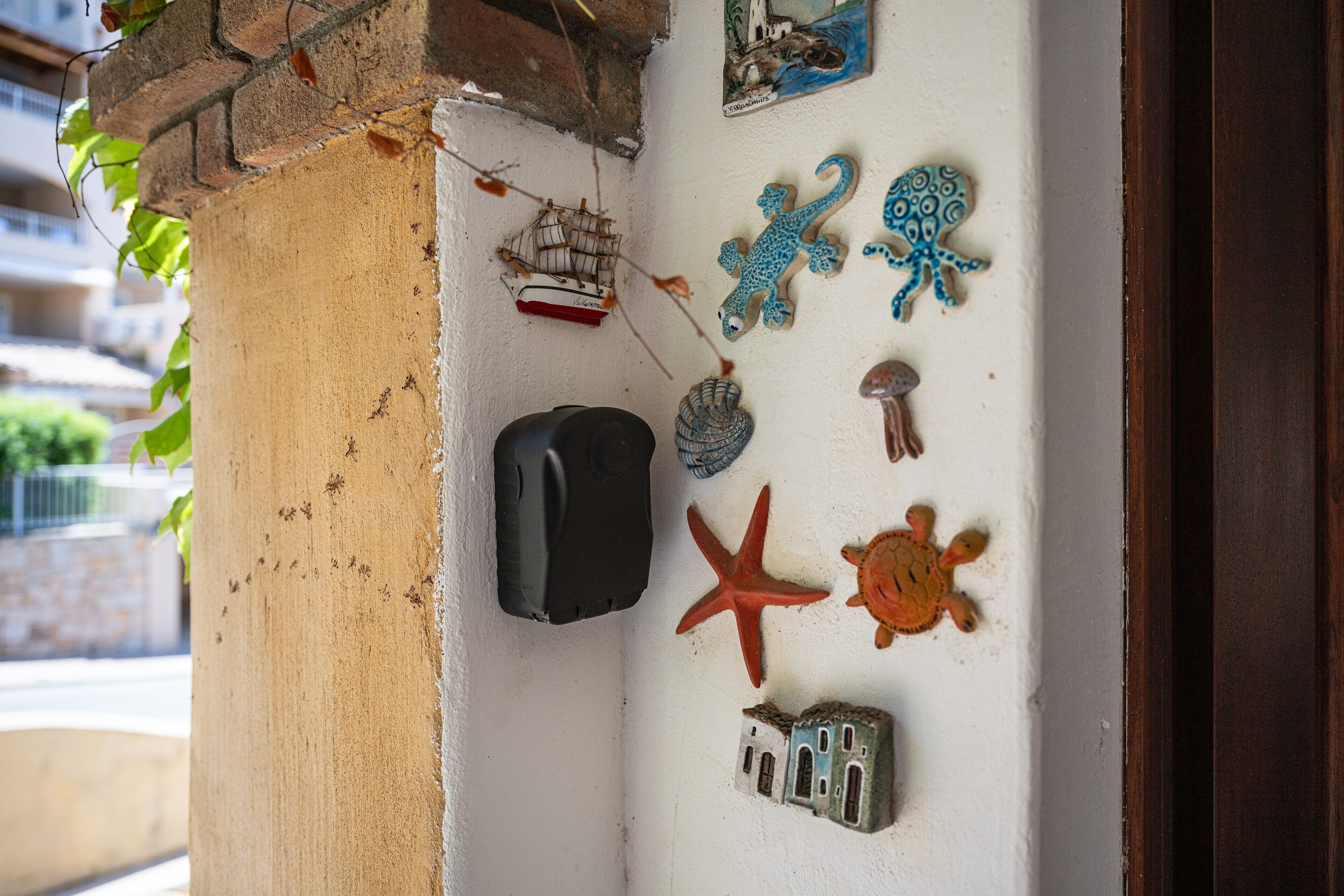 A wall with various decorative items including a ship, octopus, starfish, and a turtle.
