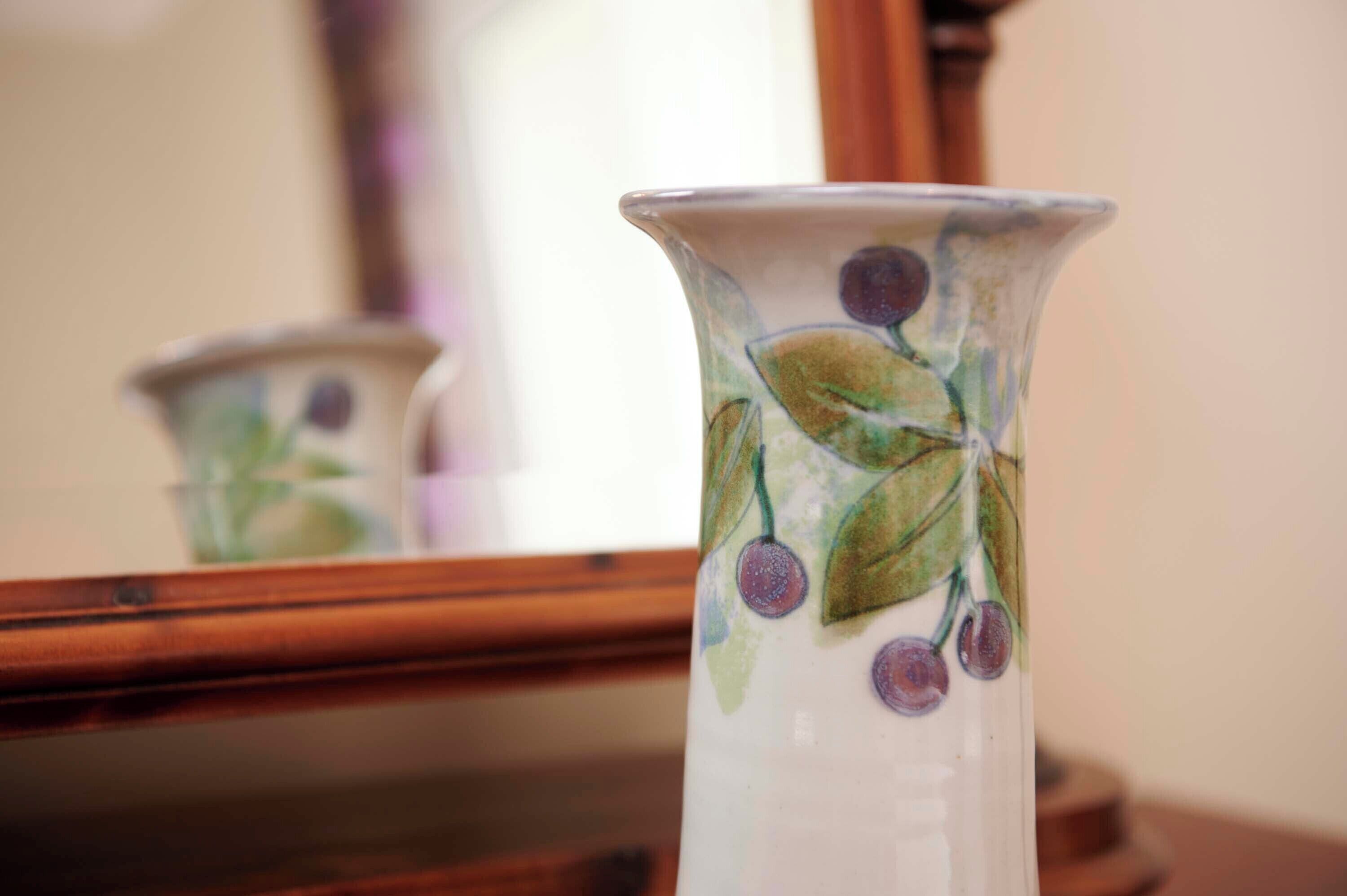 A ceramic vase with a floral design.