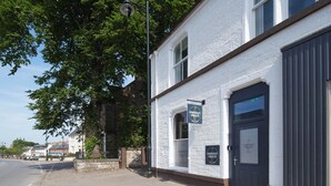A building with a sign reading "Downright Gabbler" and a large garage door. - Downright Gabbler (Beauly)