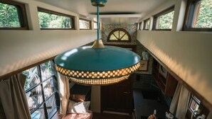 A compact kitchen with a stove, sink, and window.