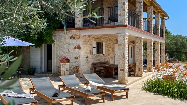 A stone building with a pool, outdoor seating, and a balcony. - Vacation home Bepo by Interhome (Poreč/Heraki)