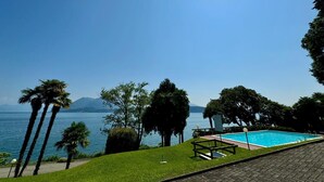 A pool area with a clear view of a lake and mountains in the background. - Lago Bello Apartament with lake view (Stresa)