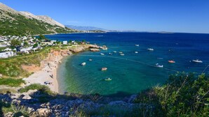 A coastal area with clear waters, boats, and a small settlement with houses and a beach. - Apt One Kostrena Sea-View Balcony & Parking, Kostrena, Croatia (Kostrena)