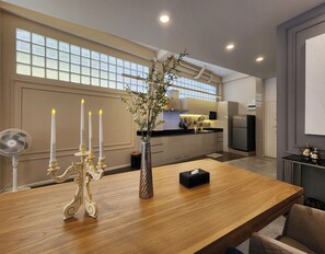 Enjoy cooking in this well-equipped kitchen with a central island, stainless steel appliances, and large windows.
