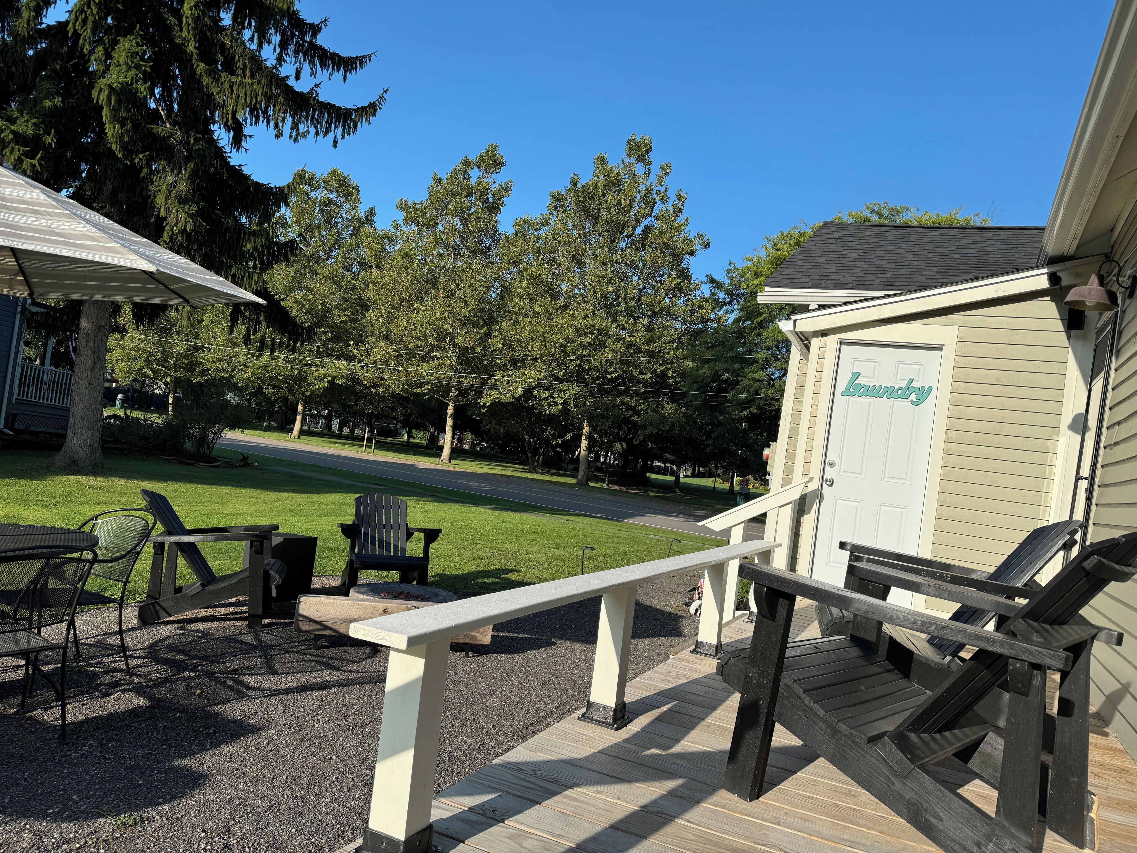 A deck with outdoor furniture, a covered seating area, and a laundry room.