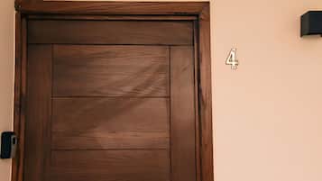 A wooden door with a number '4' on the wall to the right.