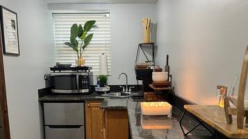 Fridge, microwave, coffee/tea maker, cookware/dishes/utensils