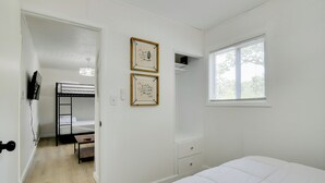 A bedroom with a bunk bed, a desk, and a window. - Table Rock Lake Apt w/ Community Dock & Fire Pits! (Kimberling City)