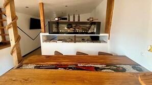 A wooden dining table with a rifle and ammunition. - Les 3 E (Englebelmer)