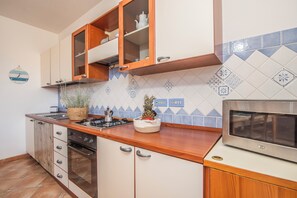 Family Apartment, Multiple Bedrooms (The Blue Whale) | Private kitchen | Fridge, microwave, oven, stovetop - The Blue Whale (La Maddalena)