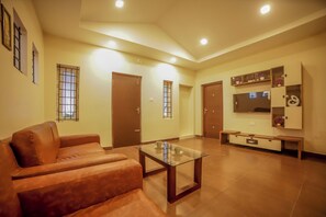 Relax in this stylish living area with a comfortable sofa, coffee table, and flat-screen TV.