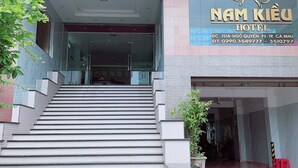 L'entrée de l'hôtel Nam Kieu, avec un escalier menant à l'entrée.