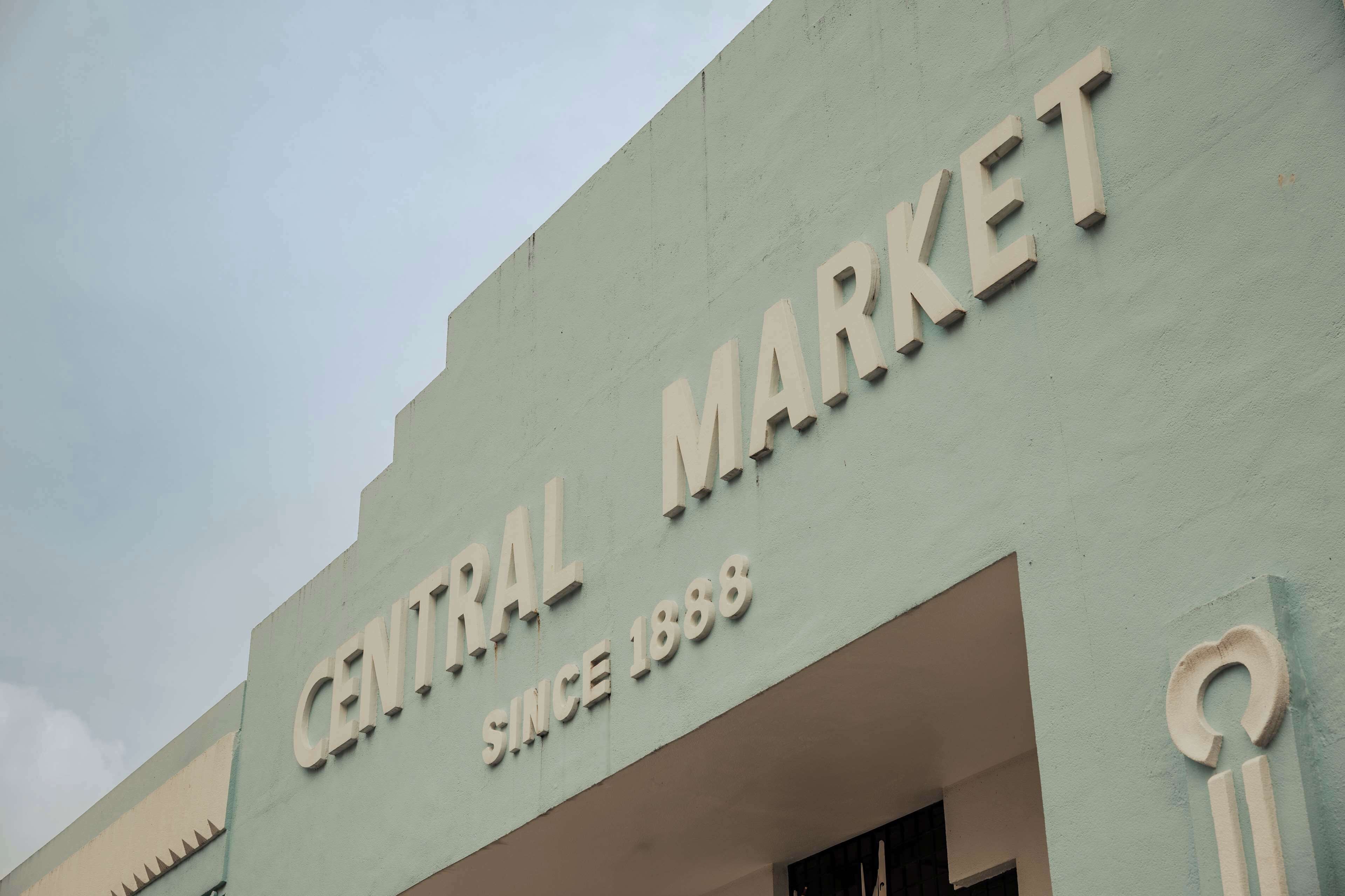 A building with the sign "CENTRAL MARKET" and "SINCE 1888" indicating its long-standing establishment.