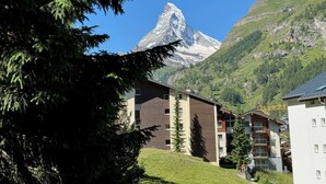 A modern building with a mountain view, including a prominent peak in the background. - Cervino (Zermatt)
